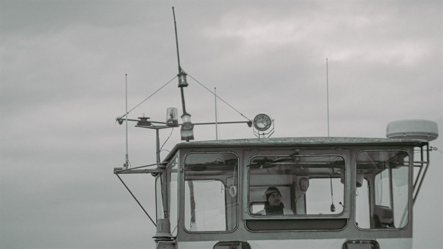 Ship bridge in cloudy weather with an officer on watch