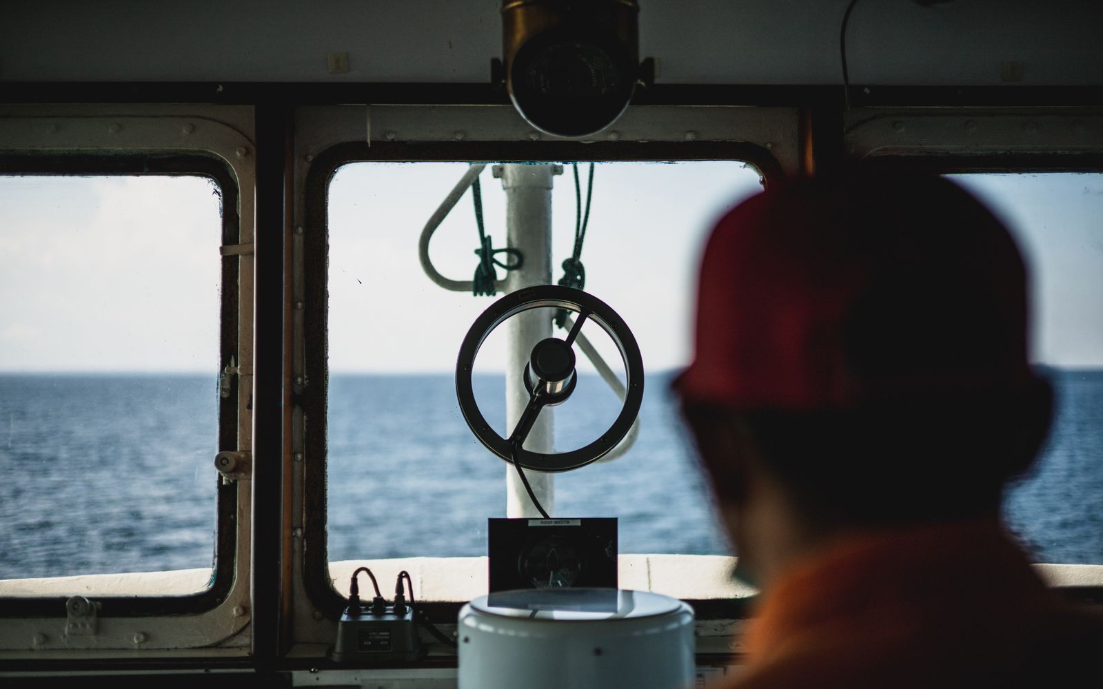 Ship bridge window looking toward the ocean horizon, the watch behind official cruise ship safety statistics