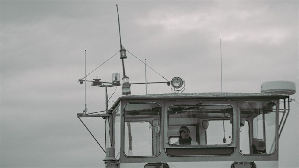 Ship bridge in cloudy weather with an officer on watch